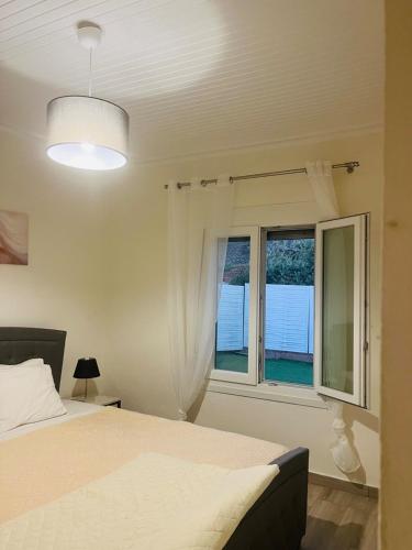 a bedroom with a bed and a window at Seagull House Thassos island in Skala Kallirachis