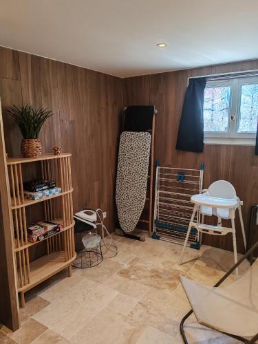 a room with wood paneled walls and a room with a bed at Gîte Drôme des collines in Anneyron