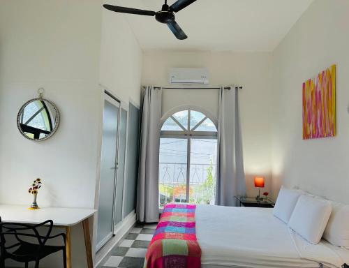 a bedroom with a bed and a window at The Quetzal in Cancún