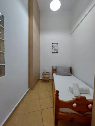 a small bedroom with a bed in a room at Pine Apartments in Ermoupoli