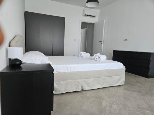 a bedroom with a large bed with a black headboard at Messina Centro Affitti in Messina