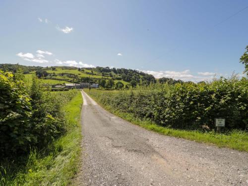 a dirt road in the middle of a field at Plas Glan Yr Afon in Abergele