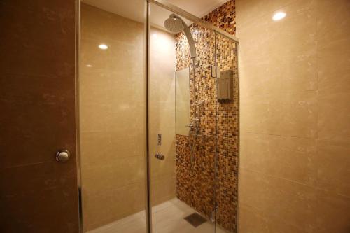a shower with a glass door in a bathroom at Hotel Cullinan Yongin in Yongin