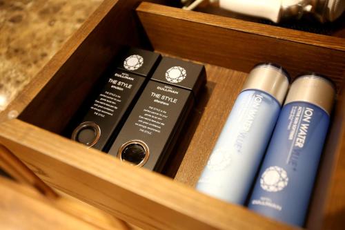a wooden box filled with books on a shelf at Hotel Cullinan Yongin in Yongin