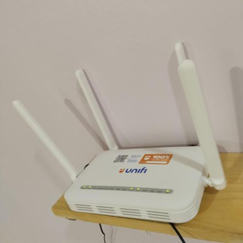 a white router sitting on top of a table at Happpy Impiana Guest House in Bentong