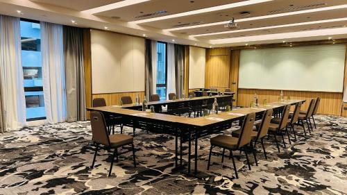 a large conference room with a long table and chairs at Holiday Inn Sepang - Airport in Sepang