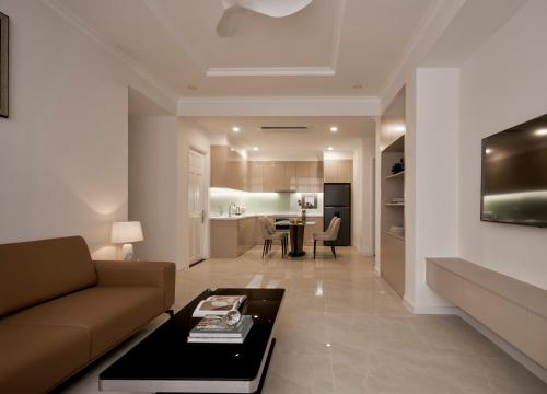 a living room with a couch and a table at Hoang Dung Hotel and Apartment by THC Group in Thuan An