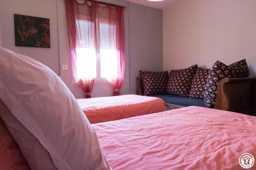 a bedroom with two beds and a couch at Sainte Maxime in LʼUnion