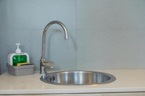 a kitchen sink with a faucet on a counter at Boomerang Village in Torre Colimena