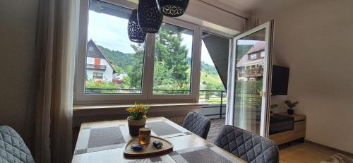 a dining room with a table and chairs and a large window at Renatas Ferienwohnung Maria in Sasbachwalden