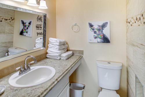 a bathroom with a sink and a toilet and a mirror at Swim, Fish and Suntan Cozy Corpus Christi Retreat in Corpus Christi