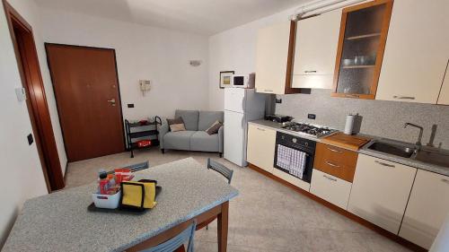 a small kitchen with a table and a counter top at Pit Stop - Bilocale inTerra di Motori, Cibo e Arte in Formigine