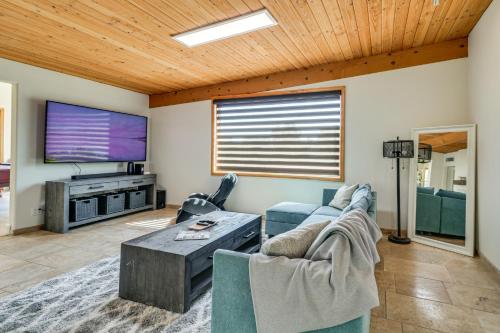 a living room with a couch and a tv at Play, Swim and Unwind Luxe Los Angeles Oasis! in Chatsworth Lake Manor