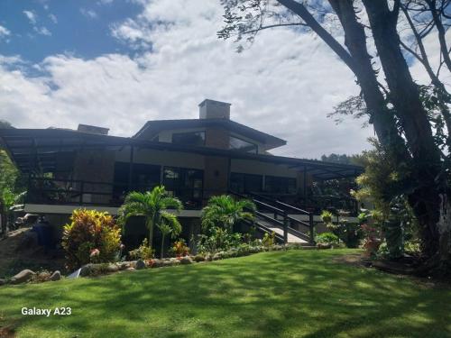 a house with a lawn in front of it at Casa Honey in Bajo Boquete