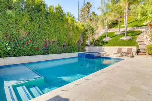 a swimming pool with blue water in a yard at Play, Swim and Unwind Luxe Los Angeles Oasis! in Chatsworth Lake Manor