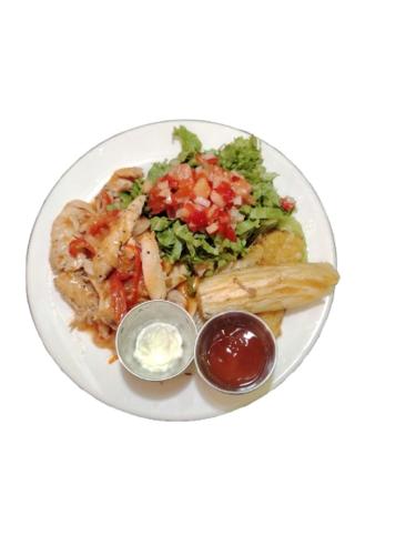 a plate of food with pasta and vegetables and sauce at Casa Club Bluaska in Sarapiquí