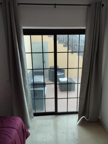 a room with a large window with a view of a patio at Villa las Cruces in Alajeró
