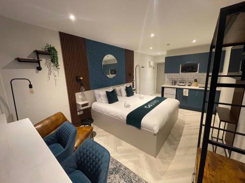 a hotel room with a large bed and a kitchen at CoStays Aparthotel - Middlesbrough in Middlesbrough