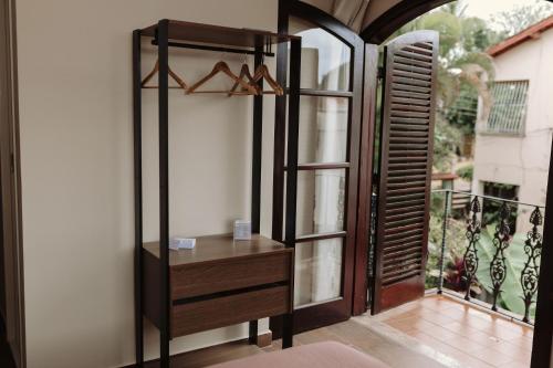 a room with a wooden dresser and a window at Casa da Coruja in Rio de Janeiro