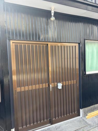 a metal garage door with a light on top at ゲストハウス宮町 Guest House Miyamachi in Ise