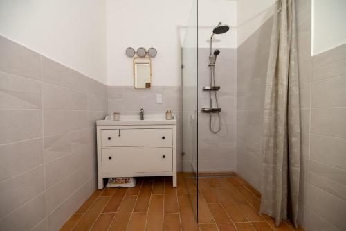 a bathroom with a sink and a shower at Viktória Kőház Köveskál in Köveskál