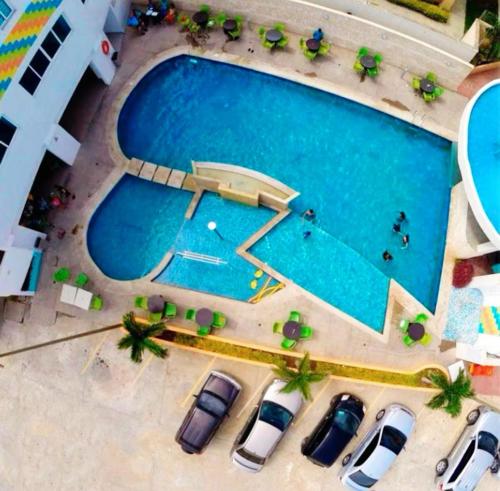 an overhead view of a swimming pool with parked cars at Hotel Aventura suite in Boca de Aroa