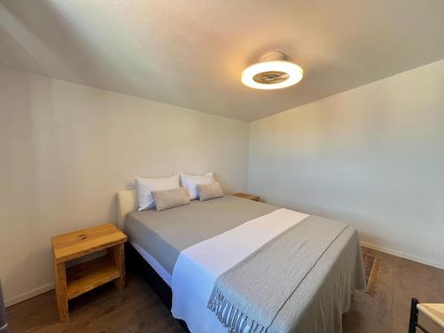 a small bedroom with a bed and a night stand at Four Points in Vir