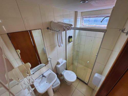 a bathroom with a toilet and a sink at Hotel Green Sunset 407 in João Pessoa
