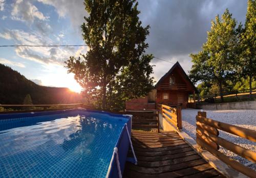a house with a swimming pool and a house at Zelena čarolija in Bioštica