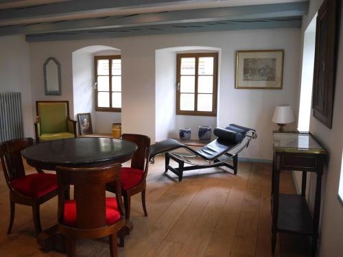 a living room with a table and chairs at Chateau de Marnand in Granges-près-Marnand