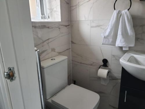 a white bathroom with a toilet and a sink at Private Room with Ensuite Bathroom & Free Parking in Birmingham