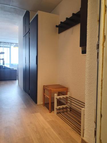 a room with a door and a wooden table at Spacieux et confortable avec piscine in Chamrousse