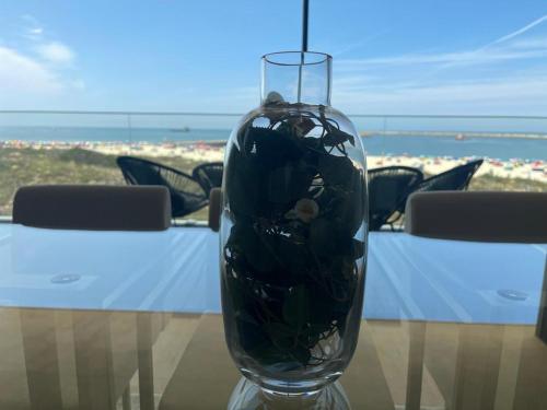 a glass vase sitting on top of a table at LUX BeACH in Praia da Barra