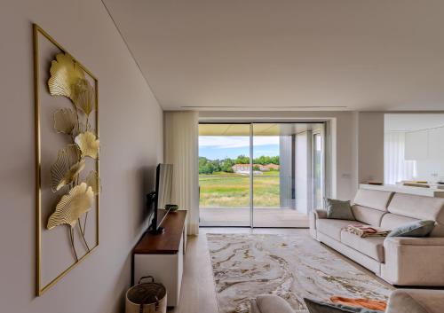 a living room with a couch and a tv at Premium Stay Barcelos in Vila Boa