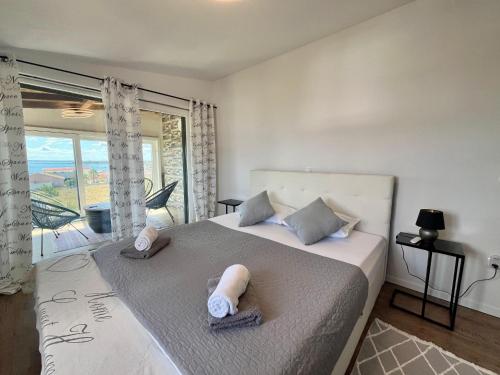 a bedroom with a bed with two towels on it at Four Points in Vir