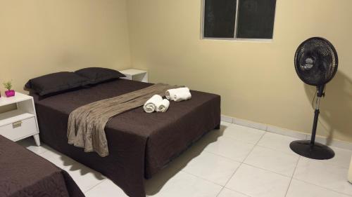 a bedroom with a bed with two towels on it at Casa moderna e mobiliada n1 com 4 camas e 2 quartos Doce refúgio in Juazeiro do Norte