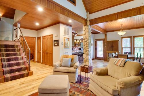 a living room with two chairs and a staircase at White River Access and Views Retreat in Gassville! in Gassville