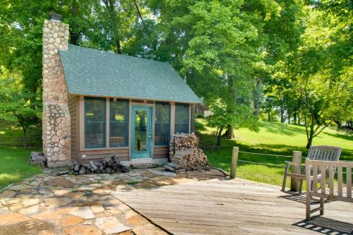 a small cabin in a park with a wooden deck at White River Access and Views Retreat in Gassville! in Gassville