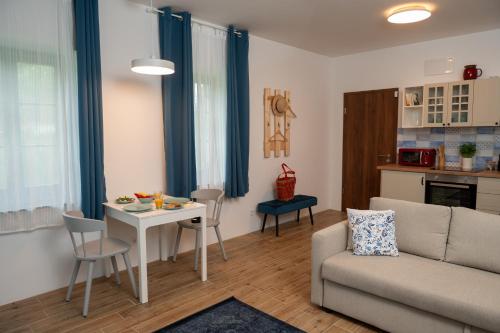 a living room with a couch and a table at Viktória Kőház Köveskál in Köveskál