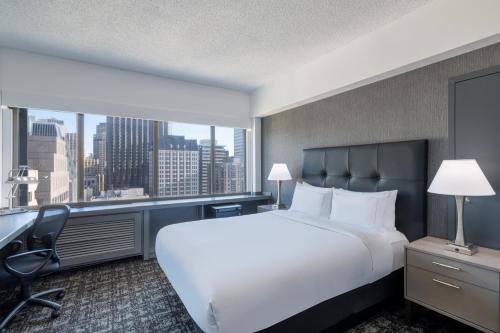 a hotel room with a large bed and a large window at Hilton San Francisco Financial District in San Francisco