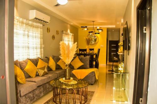 a living room with a couch and a table at Oasis Eden Villa in Kupuis