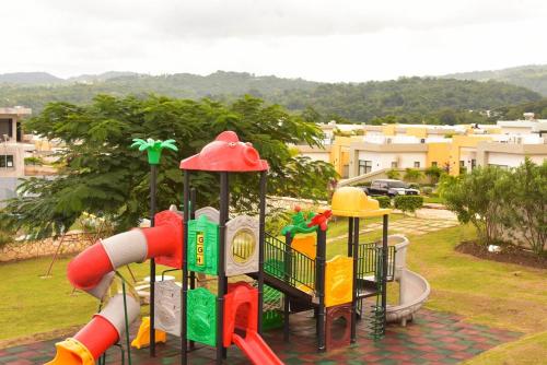 a playground in a park with a slide at Oasis Eden Villa in Kupuis