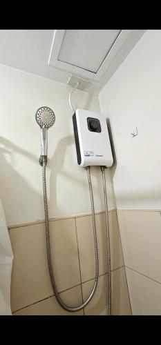 a shower in a bathroom with a blow dryer at Camella Northpoint in Davao City