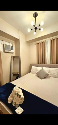 a bedroom with a bed with a hat on it at Camella Northpoint in Davao City
