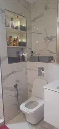 a white bathroom with a toilet and a sink at Villa au centre ville Rabat in Rabat