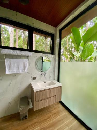 a bathroom with a sink and a mirror at Jako Doma Beachfront Cabana in San Francisco