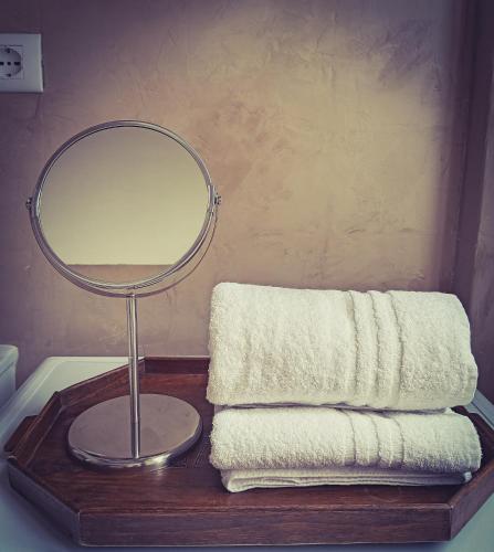 a table with a mirror and towels on it at La Casina in Murlo