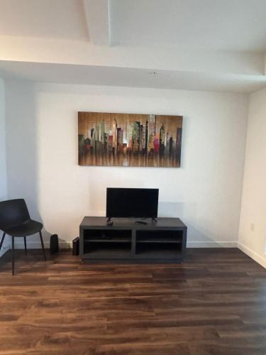 a living room with a table and a painting on the wall at Awesome Loft at Hollywood FREE Parking in Los Angeles