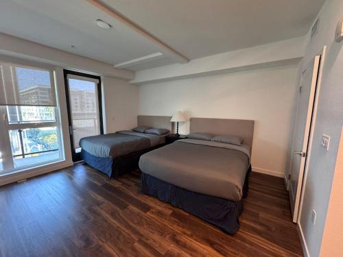 a room with two beds and a window at Awesome Loft at Hollywood FREE Parking in Los Angeles