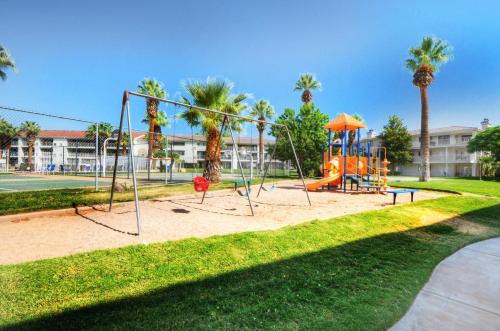 a playground in a park with palm trees at Las Palmas 1805 Shared Pool and Hot Tub, Great Clubhouse Amenities in St. George